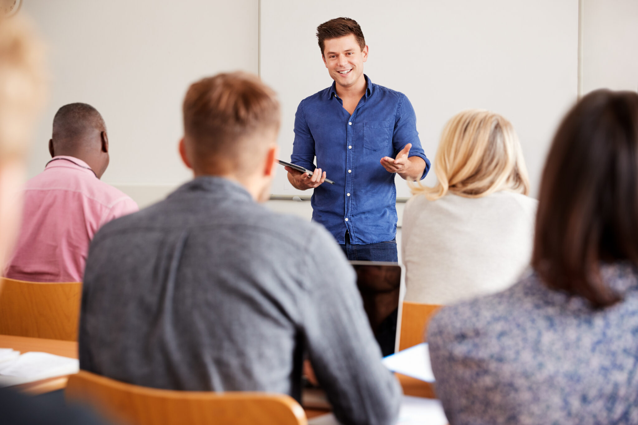 Instructor speaking to a group of attentive students